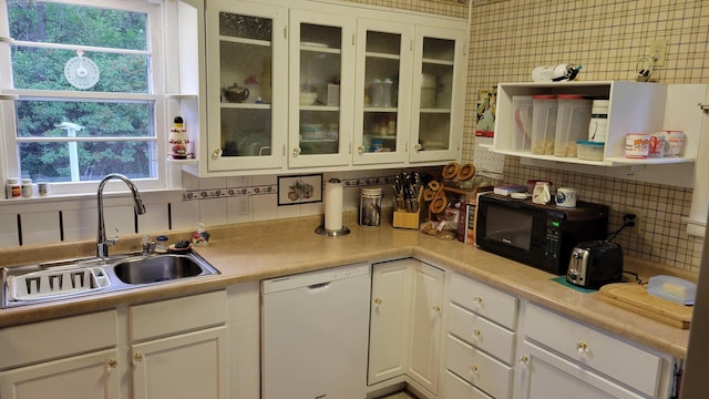 112 240th St N, Eglon Twp, MN 56549 - kitchen featuring white dishwasher, black microwave, tasteful backsplash, white cabinetry, and healthy amount of natural light