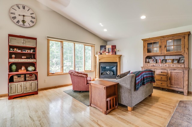 2607 Forest View Dr NE, Bemidji, MN 56601 - living room with vaulted ceiling, light wood finished floors, a glass covered fireplace, recessed lighting, and baseboards