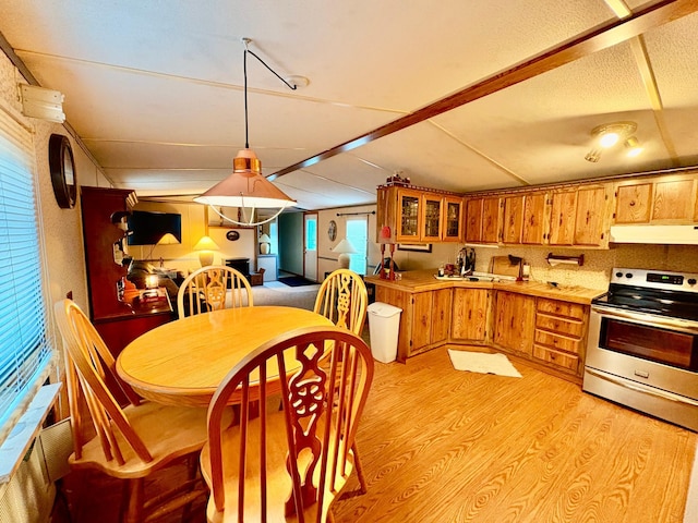 2683 22nd St NW Lot 8, Baudette, MN 56623 - kitchen with stainless steel electric stove, under cabinet range hood, light wood-type flooring, and brown cabinets