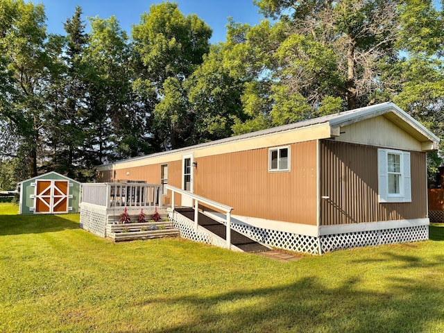 2683 22nd St NW Lot 8, Baudette, MN 56623 - rear view of house with a lawn and a storage unit
