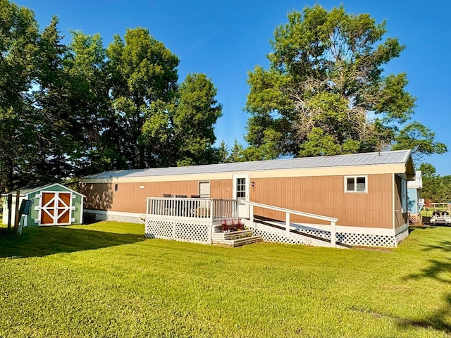 2683 22nd St NW Lot 8, Baudette, MN 56623 - rear view of property with a shed, a yard, and a metal roof