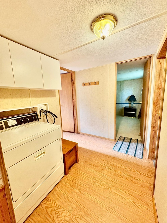 2683 22nd St NW Lot 8, Baudette, MN 56623 - laundry room featuring washer / clothes dryer, cabinet space, a textured ceiling, and light wood-style floors