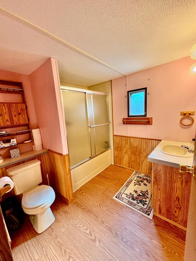 2683 22nd St NW Lot 8, Baudette, MN 56623 - bathroom featuring wood finished floors, wainscoting, vanity, a textured ceiling, and wood walls