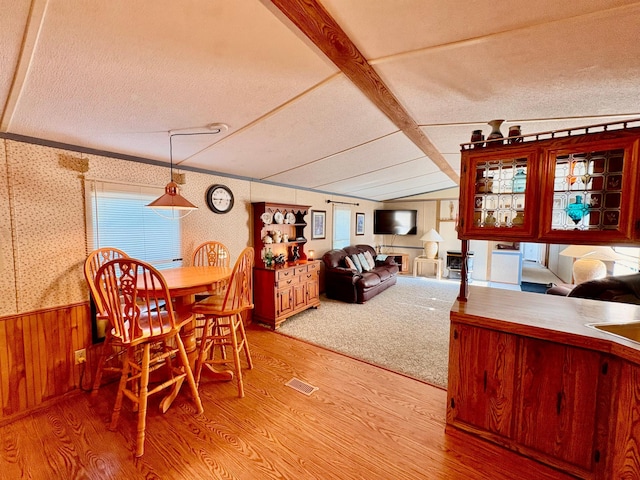 2683 22nd St NW Lot 8, Baudette, MN 56623 - dining room featuring wallpapered walls, light wood-style flooring, a textured ceiling, lofted ceiling, and wainscoting