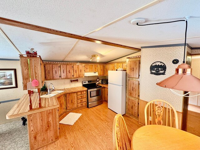 2683 22nd St NW Lot 8, Baudette, MN 56623 - kitchen featuring freestanding refrigerator, stainless steel electric stove, under cabinet range hood, light countertops, and a peninsula