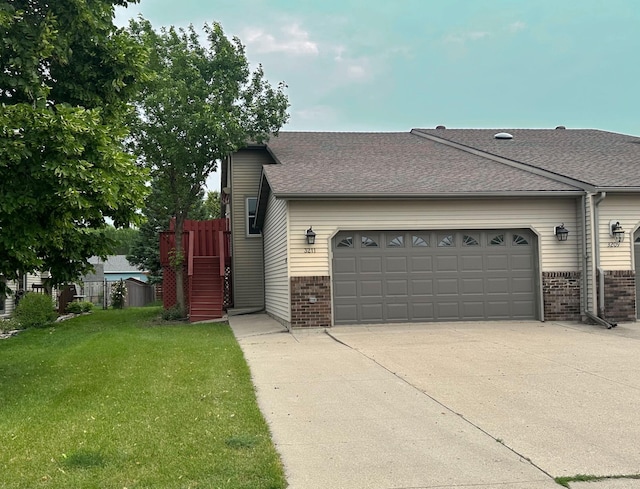 3211 30th Ave S, Fargo, ND 58103 - view of home's exterior featuring brick siding, a garage, driveway, and a yard