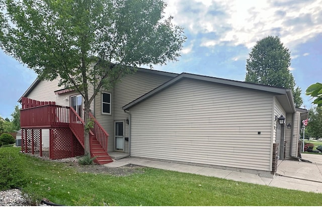 3211 30th Ave S, Fargo, ND 58103 - rear view of house featuring stairway, a deck, and a lawn