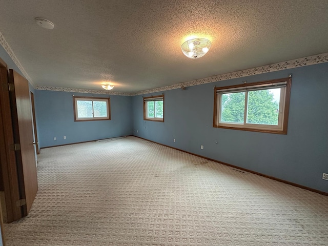 3211 30th Ave S, Fargo, ND 58103 - spare room with carpet floors, a textured ceiling, and a smoke detector
