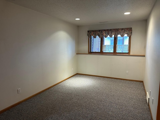 3211 30th Ave S, Fargo, ND 58103 - carpeted empty room featuring a textured ceiling and recessed lighting