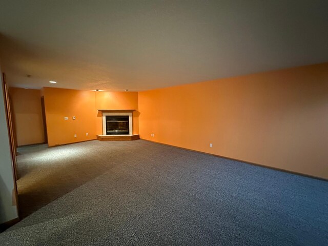 3211 30th Ave S, Fargo, ND 58103 - unfurnished living room with a glass covered fireplace, carpet floors, and recessed lighting