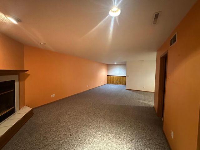 3211 30th Ave S, Fargo, ND 58103 - unfurnished living room with a tiled fireplace and carpet