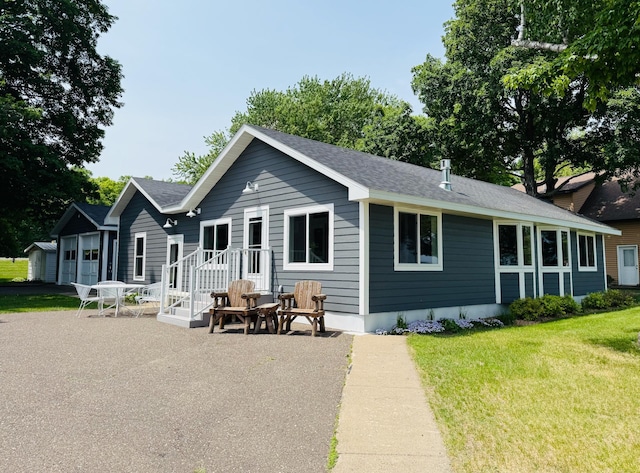 15127 Twilight Rd, Kathio Twp, MN 56359 - back of house featuring a yard, a patio, and roof with shingles