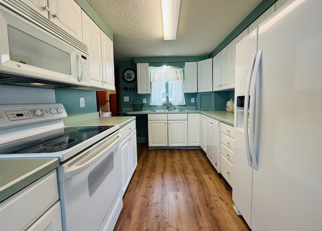 15127 Twilight Rd, Kathio Twp, MN 56359 - kitchen with white appliances, dark wood finished floors, white cabinetry, a textured ceiling, and a sink