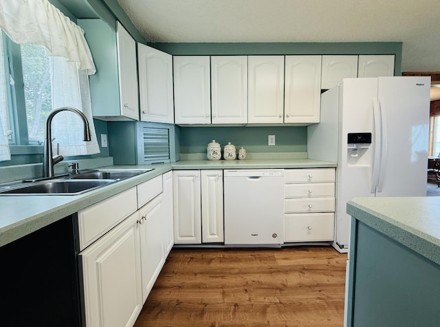 15127 Twilight Rd, Kathio Twp, MN 56359 - kitchen with a sink, white appliances, and light countertops