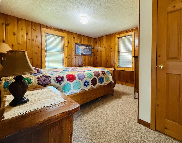 15127 Twilight Rd, Kathio Twp, MN 56359 - carpeted bedroom featuring wooden walls, a textured ceiling, and baseboards
