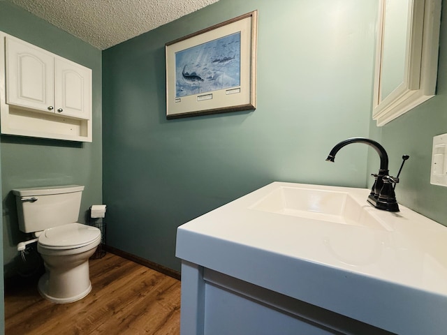 15127 Twilight Rd, Kathio Twp, MN 56359 - bathroom with toilet, wood finished floors, vanity, and a textured ceiling