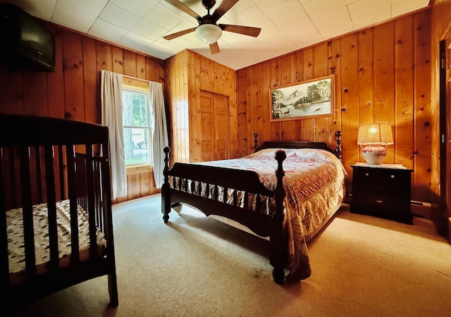 15127 Twilight Rd, Kathio Twp, MN 56359 - bedroom featuring carpet flooring, wooden walls, and a ceiling fan