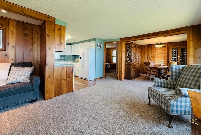 15127 Twilight Rd, Kathio Twp, MN 56359 - living area featuring wood walls, light colored carpet, and a textured ceiling