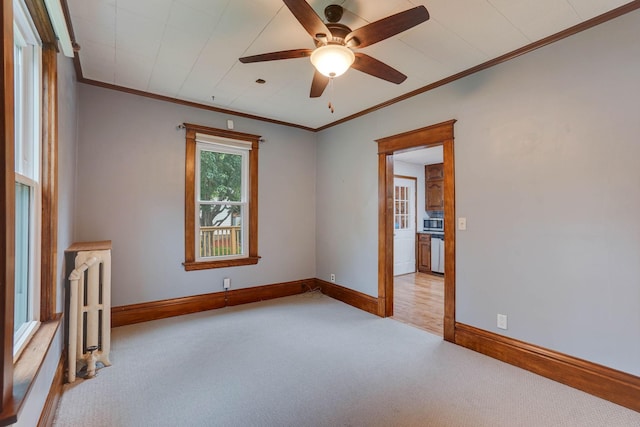 1173 Matilda St, Saint Paul, MN 55117 - unfurnished room featuring radiator heating unit, carpet, crown molding, and a ceiling fan