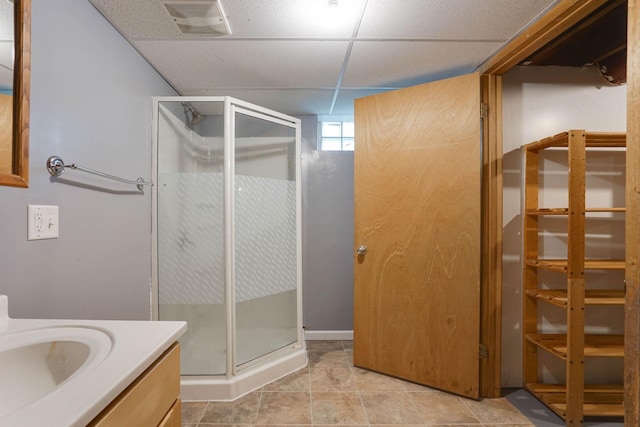 1173 Matilda St, Saint Paul, MN 55117 - bathroom with vanity, a shower stall, a paneled ceiling, and tile patterned floors
