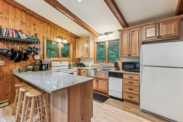 2225 Antler Lake Ct, Milltown, WI 54858 - kitchen with white appliances, wood walls, a peninsula, a kitchen bar, and light stone counters