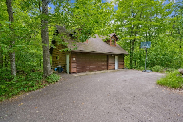 2225 Antler Lake Ct, Milltown, WI 54858 - view of property exterior featuring a detached garage, an outbuilding, and a shingled roof