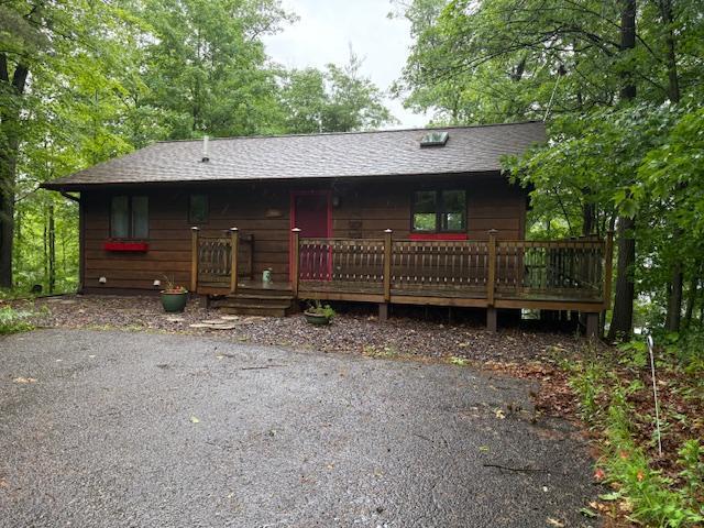 2225 Antler Lake Ct, Milltown, WI 54858 - rustic home featuring a shingled roof and a deck
