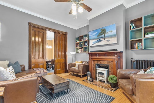 737 5th St E, Saint Paul, MN 55106 - living area featuring radiator heating unit, wood-type flooring, ceiling fan, and ornamental molding