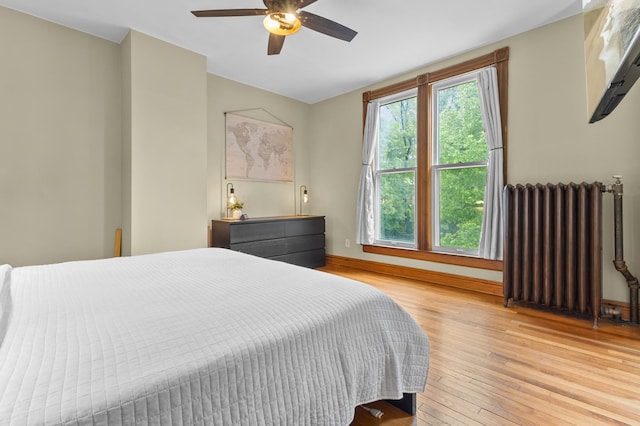 737 5th St E, Saint Paul, MN 55106 - bedroom with radiator, light wood-type flooring, and ceiling fan