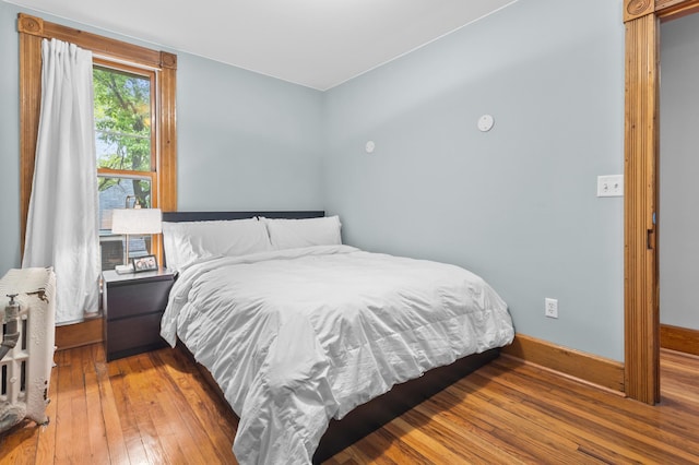 737 5th St E, Saint Paul, MN 55106 - bedroom with wood-type flooring and radiator