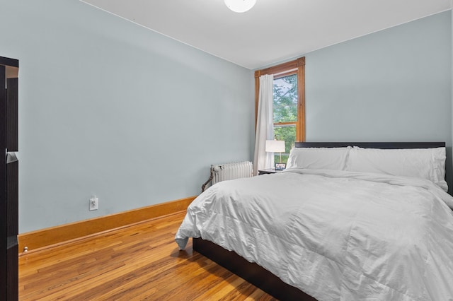 737 5th St E, Saint Paul, MN 55106 - bedroom featuring radiator and wood finished floors
