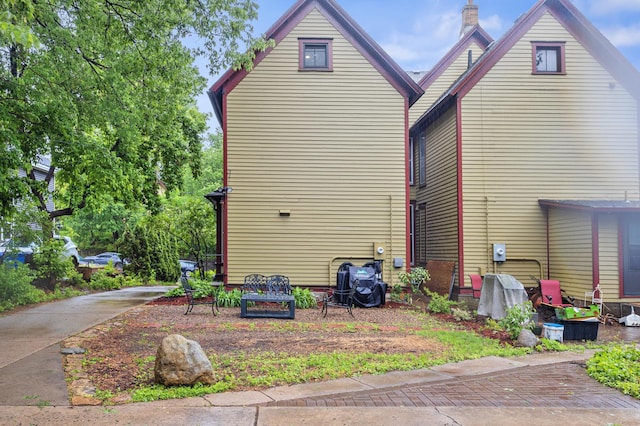 737 5th St E, Saint Paul, MN 55106 - view of side of property featuring a chimney