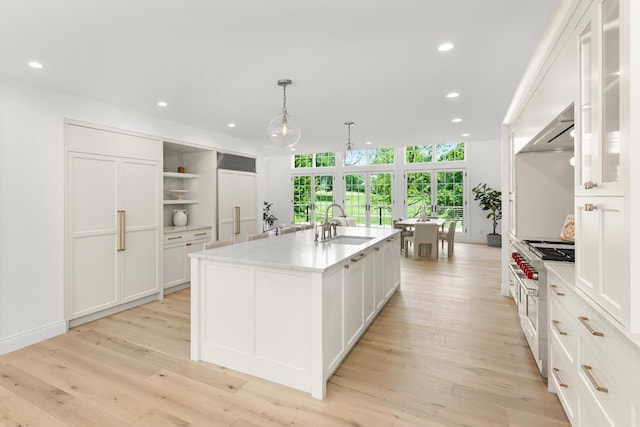 4603 Merilane Ave, Edina, MN 55436 - kitchen featuring range with two ovens, wall chimney range hood, recessed lighting, white cabinets, and open shelves