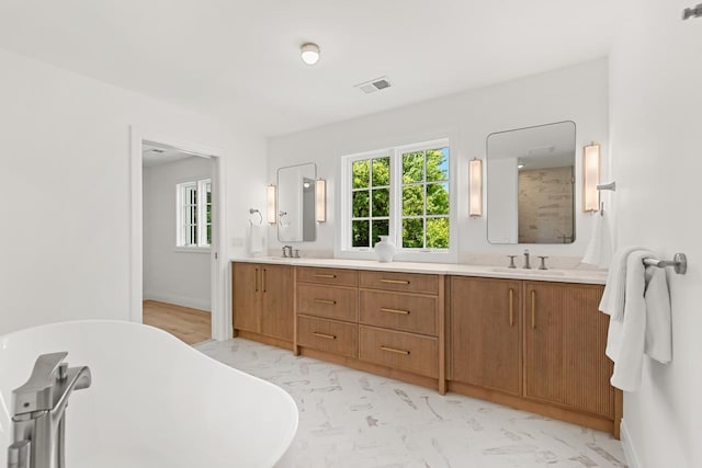 4603 Merilane Ave, Edina, MN 55436 - full bath with double vanity, a freestanding tub, and marble finish floors