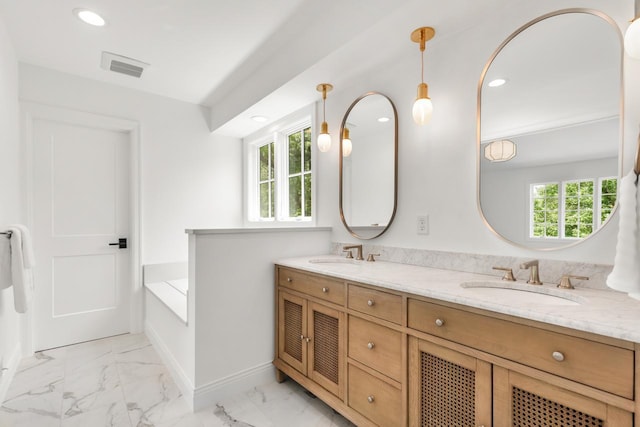 4603 Merilane Ave, Edina, MN 55436 - bathroom featuring double vanity, marble look tile flooring, recessed lighting, and a bath