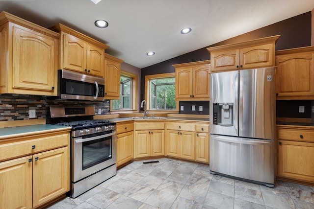 2131 111th Ln NW, Coon Rapids, MN 55433 - kitchen with stainless steel appliances, vaulted ceiling, backsplash, and recessed lighting