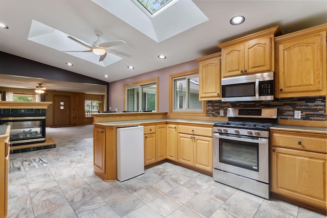2131 111th Ln NW, Coon Rapids, MN 55433 - kitchen with stainless steel appliances, a skylight, ceiling fan, a peninsula, and lofted ceiling