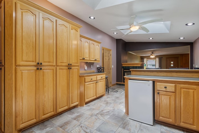 2131 111th Ln NW, Coon Rapids, MN 55433 - kitchen featuring a skylight, ceiling fan, recessed lighting, and light brown cabinets
