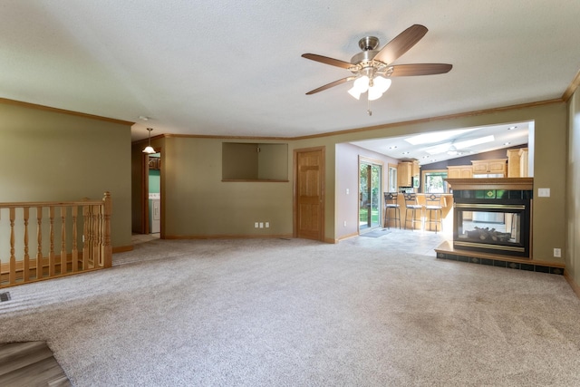 2131 111th Ln NW, Coon Rapids, MN 55433 - unfurnished living room featuring ornamental molding, a ceiling fan, vaulted ceiling, light colored carpet, and a fireplace