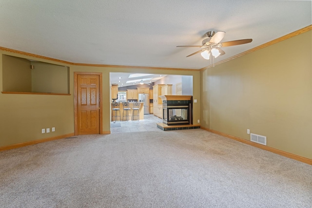 2131 111th Ln NW, Coon Rapids, MN 55433 - unfurnished living room with ceiling fan, light carpet, a multi sided fireplace, and crown molding