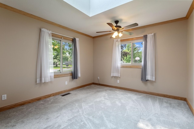 2131 111th Ln NW, Coon Rapids, MN 55433 - carpeted empty room featuring plenty of natural light, a skylight, crown molding, and a ceiling fan