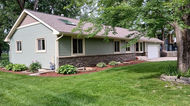 2131 111th Ln NW, Coon Rapids, MN 55433 - ranch-style house with stone siding, a front yard, a shingled roof, an attached garage, and concrete driveway