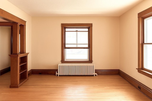 3140 Fremont Ave S, Minneapolis, MN 55408 - empty room featuring radiator and light wood finished floors