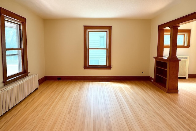 3140 Fremont Ave S, Minneapolis, MN 55408 - unfurnished room with radiator, light wood-style flooring, and radiator heating unit