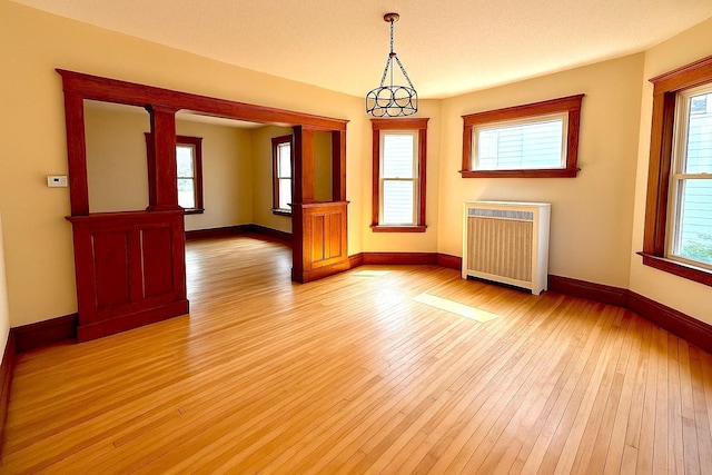 3140 Fremont Ave S, Minneapolis, MN 55408 - unfurnished room featuring radiator and light wood finished floors