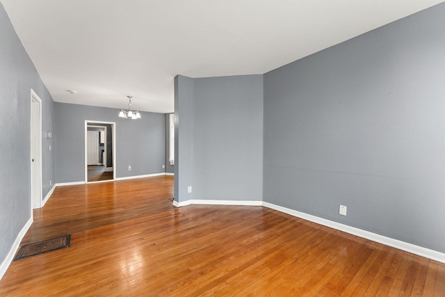 984 Iglehart Ave, Saint Paul, MN 55104 - empty room with a chandelier and light wood finished floors