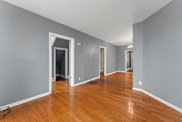 984 Iglehart Ave, Saint Paul, MN 55104 - empty room with a chandelier and light wood finished floors
