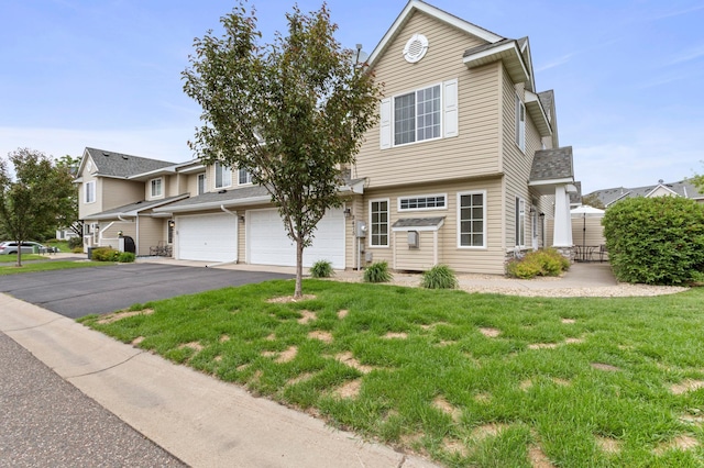 8475 121st Ave N, Champlin, MN 55316 - view of front facade featuring driveway, a garage, and a front yard
