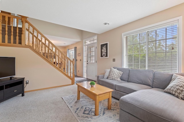 8475 121st Ave N, Champlin, MN 55316 - carpeted living area featuring stairway and baseboards