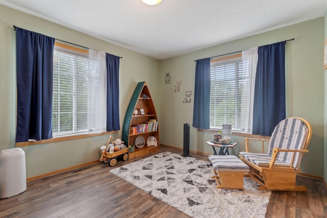 8475 121st Ave N, Champlin, MN 55316 - sitting room with wood finished floors and baseboards